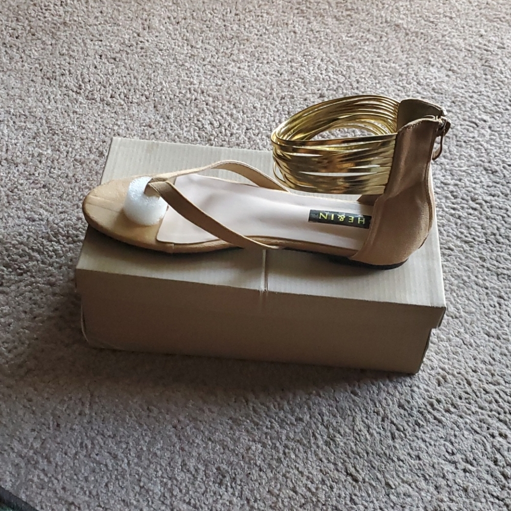 A pair of gold sandals size 10
